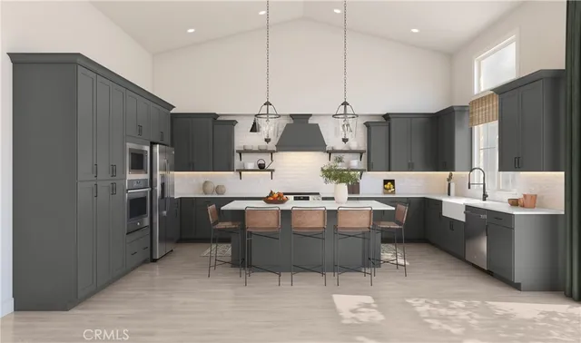 a large kitchen with kitchen island a sink stove and refrigerator