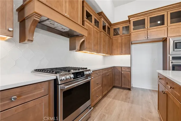 a kitchen with stainless steel appliances granite countertop a stove and a refrigerator