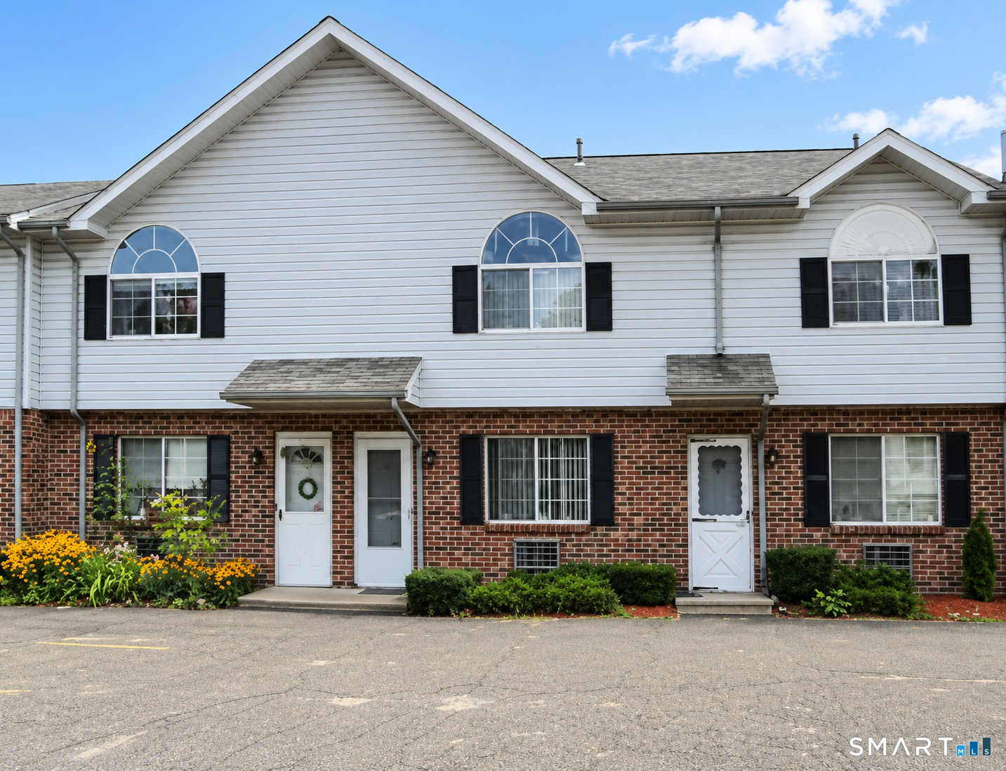 975 Meriden Road, Unit 101 Waterbury, CT 06705 - Photo 1 of 28 a front view of a house with a yard