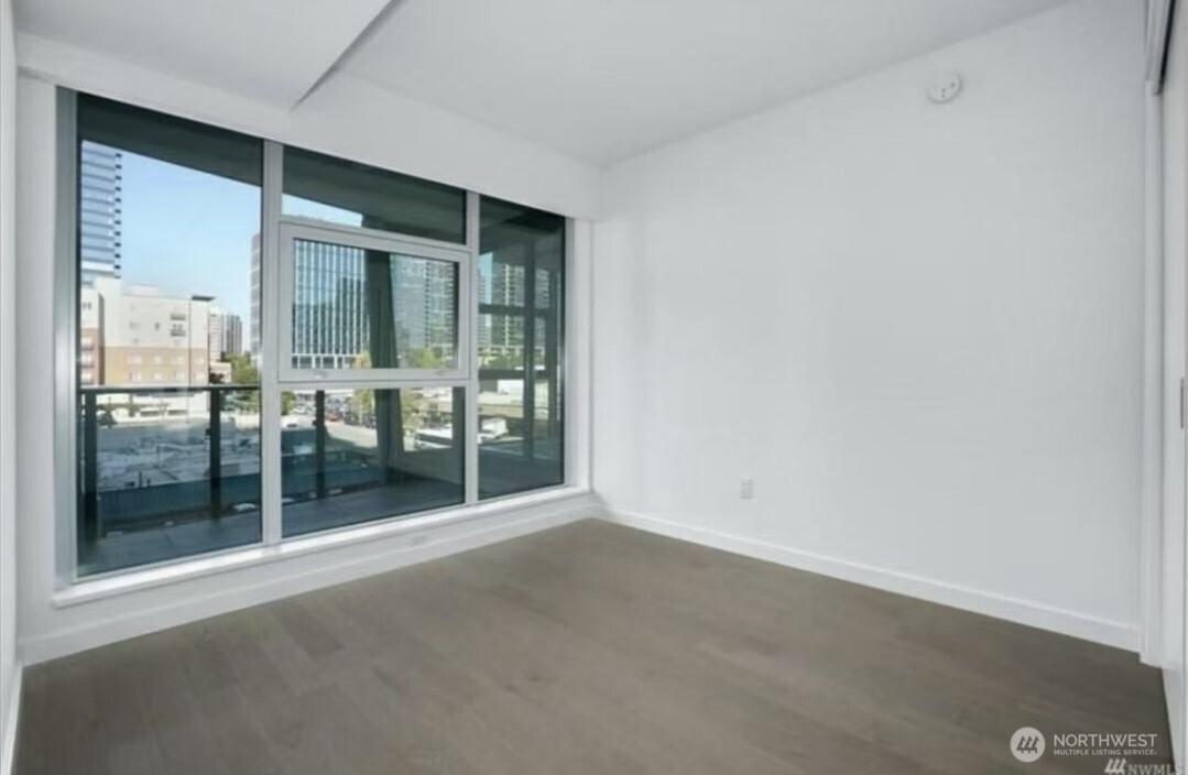 188 Bellevue Way Northeast, Unit 308 Bellevue, WA 98004 - Photo 13 of 19 an empty room with sliding glass door and outer view
