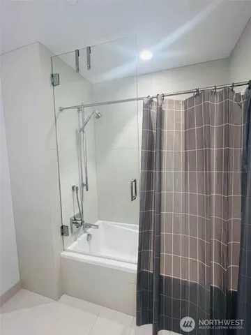 a bathroom with a double vanity sink toilet and shower