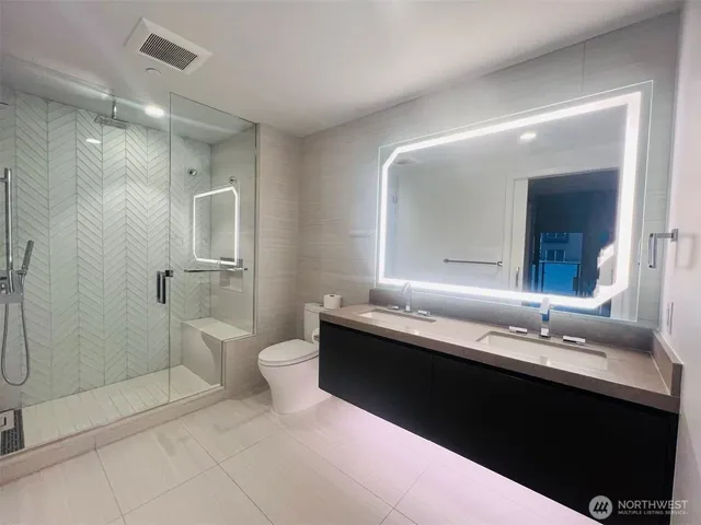 a bathroom with a double vanity sink and mirror