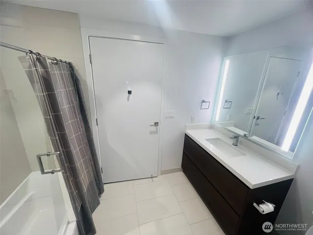 a bathroom with a sink toilet and mirror