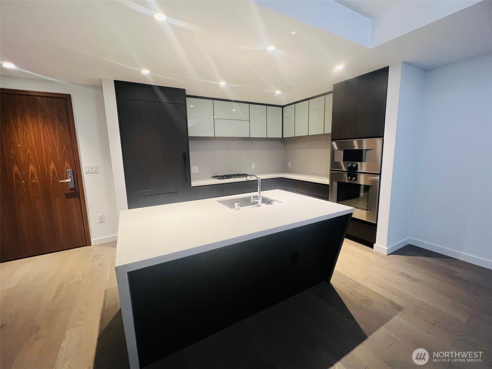 188 Bellevue Way Northeast, Unit 308 Bellevue, WA 98004 - Photo 19 of 19 a large white kitchen with a sink and refrigerator