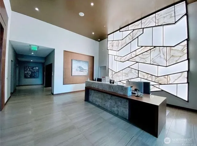 a view of entryway and hall with wooden floor