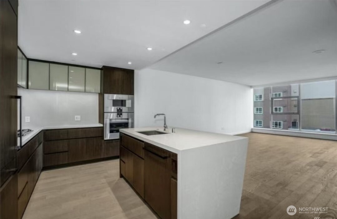 188 Bellevue Way Northeast, Unit 308 Bellevue, WA 98004 - Photo 10 of 19 a kitchen with stainless steel appliances granite countertop a sink and cabinets