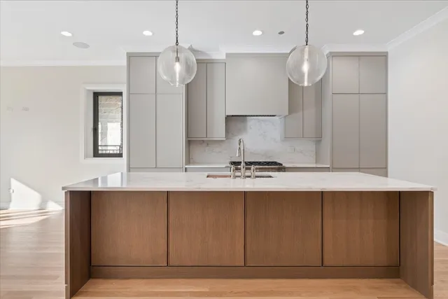 a kitchen with stainless steel appliances granite countertop a sink a stove and a wooden floors