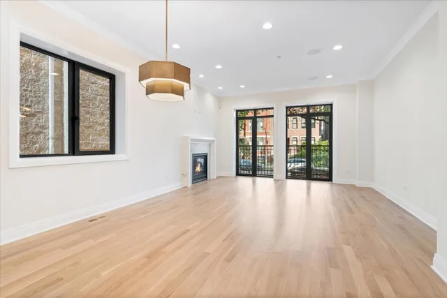 a view of a room with a fireplace and wooden floor
