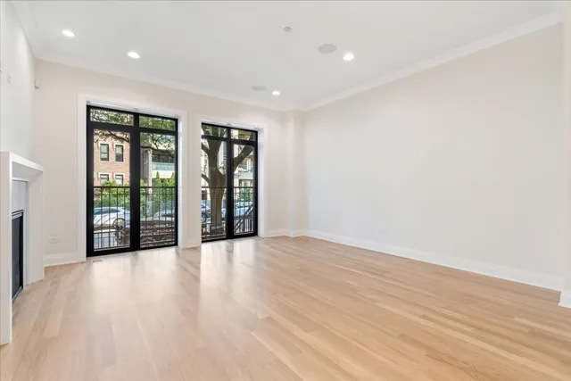 a large kitchen with stainless steel appliances granite countertop a lot of counter space and wooden floors