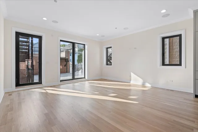 a large bedroom with a bed and a large window