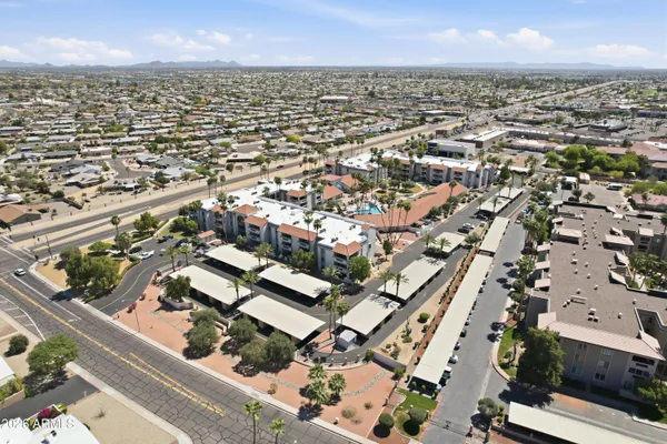 an aerial view of multi story residential apartment building with yard