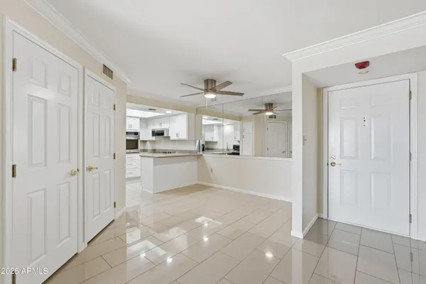 a view of a kitchen with white cabinets
