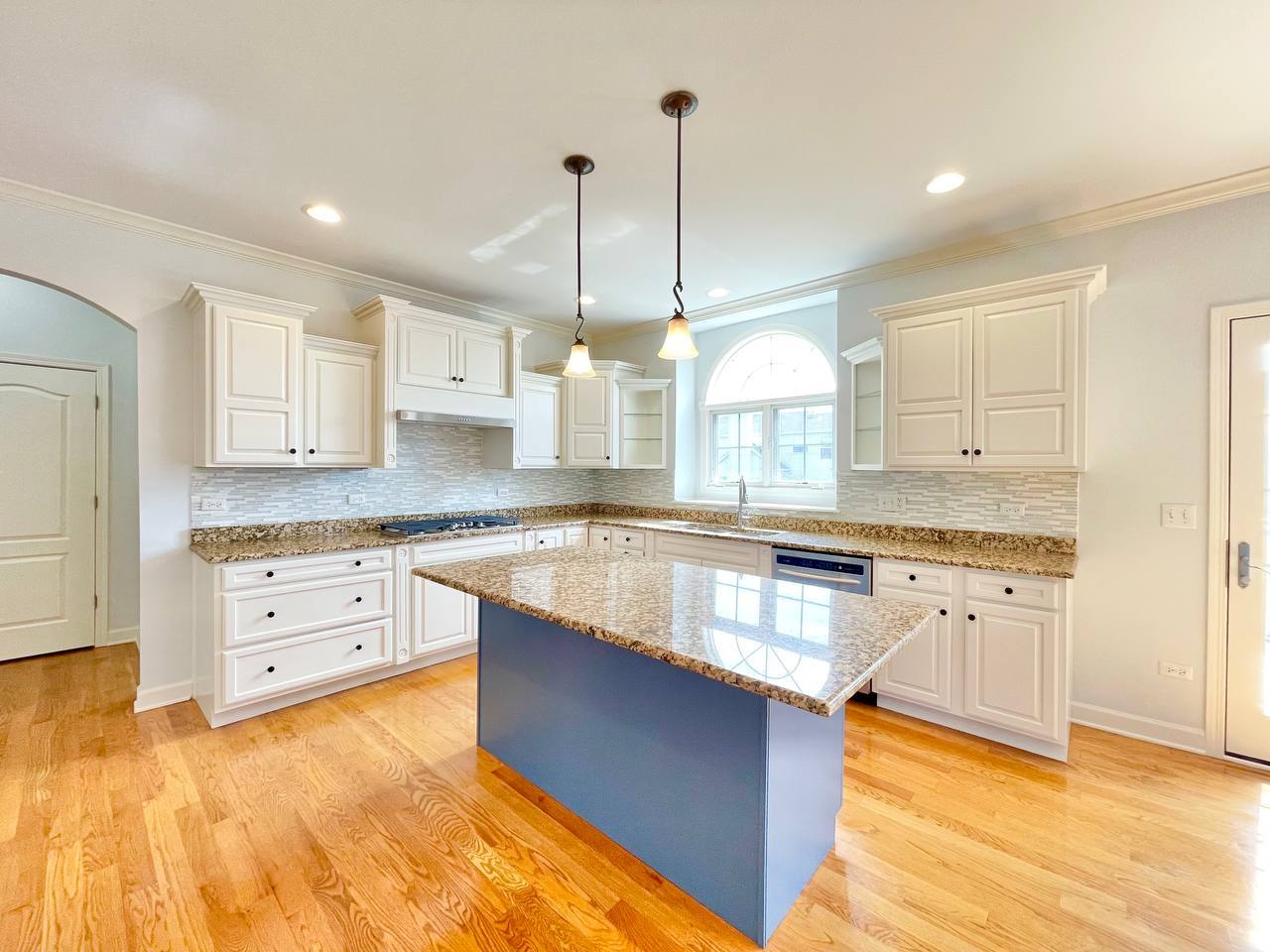 4324 Champion Road Naperville, IL 60564 - Photo 16 of 47 a large kitchen with kitchen island granite countertop a stove a sink a center island and cabinets