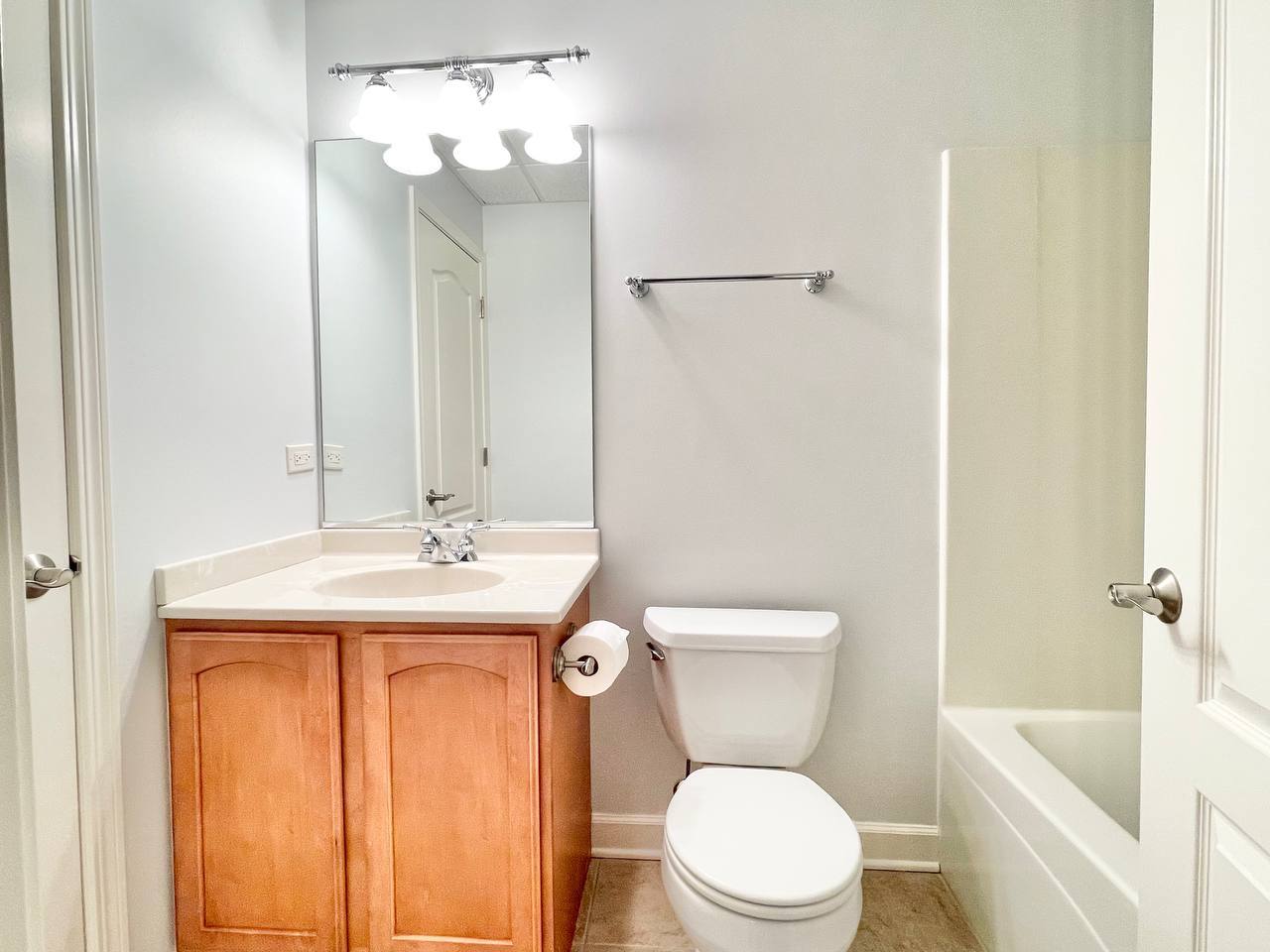 4324 Champion Road Naperville, IL 60564 - Photo 44 of 47 a bathroom with a sink a toilet and shower curtain