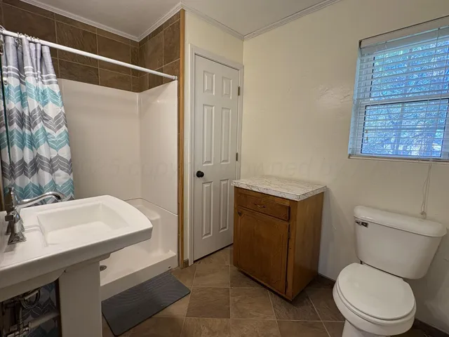 a bathroom with a sink mirror toilet and shower