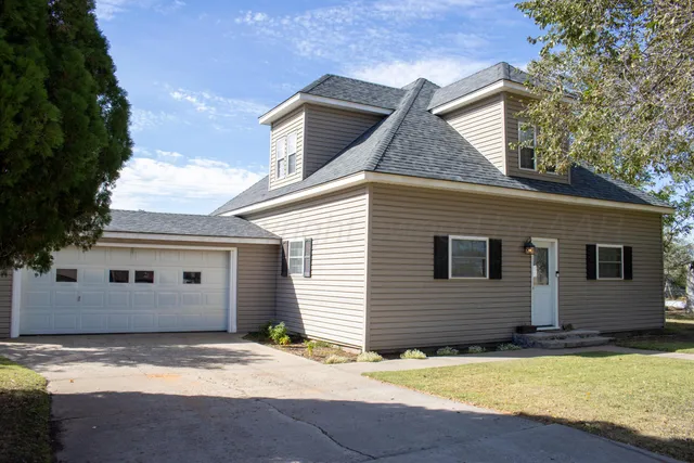 a view of house with backyard space