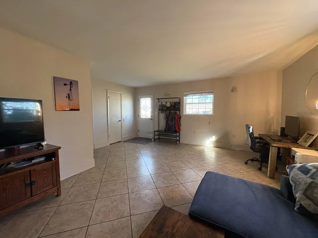 a view of a livingroom with workspace and a couch