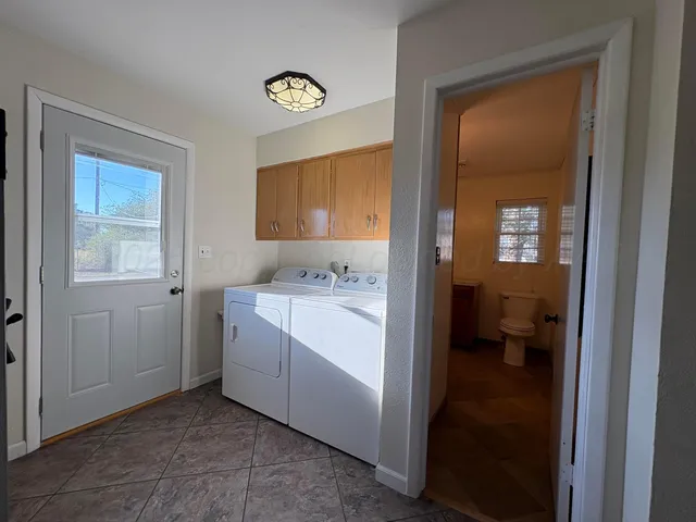 a room with a refrigerator and a sink