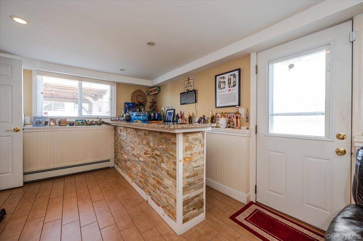 22 Cheshire Road Inwood, NY 11096 - Photo 11 of 25 a kitchen with sink cabinets and window