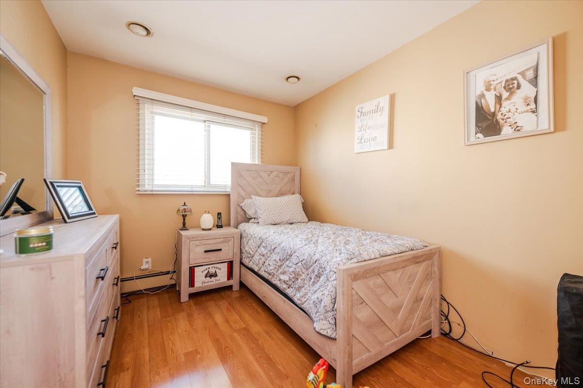 22 Cheshire Road Inwood, NY 11096 - Photo 14 of 25 a bedroom with a bed and a desk