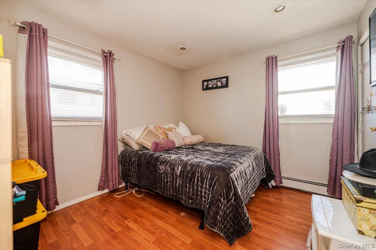 22 Cheshire Road Inwood, NY 11096 - Photo 15 of 25 a bedroom with a bed and a window