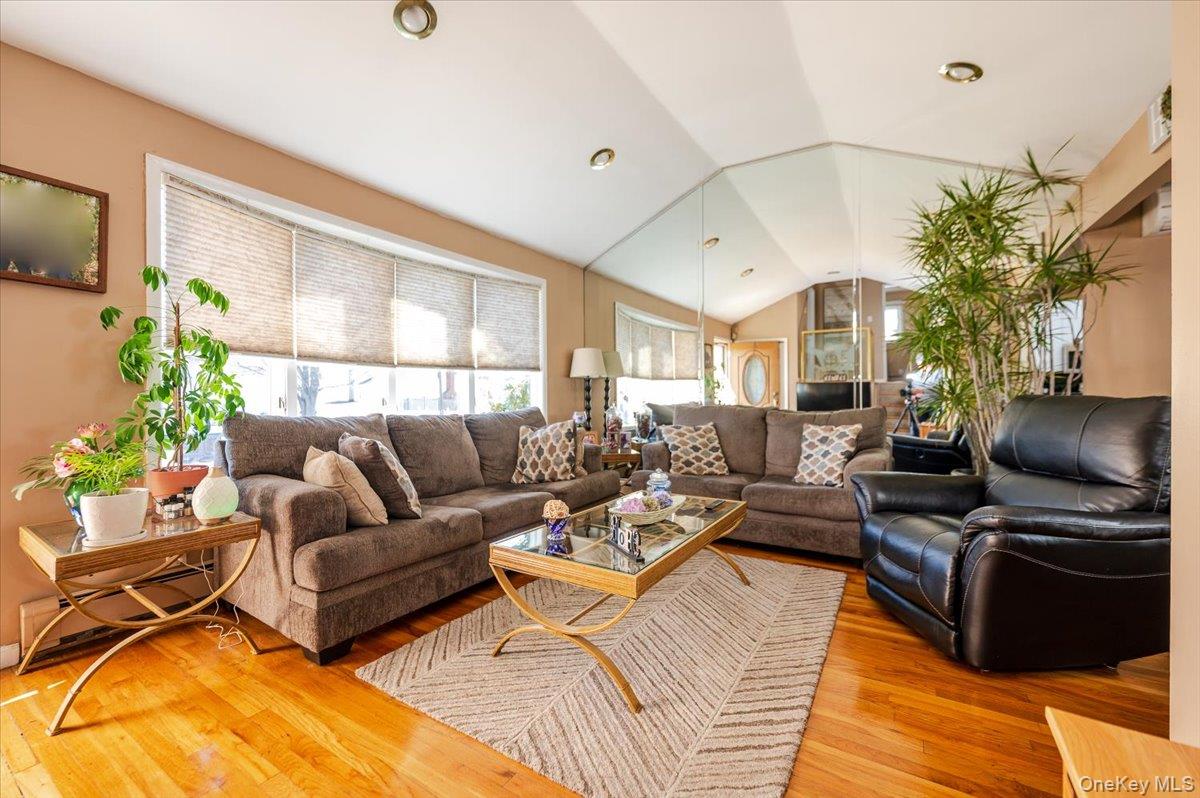 22 Cheshire Road Inwood, NY 11096 - Photo 2 of 25 a living room with furniture a dining table and a potted plant