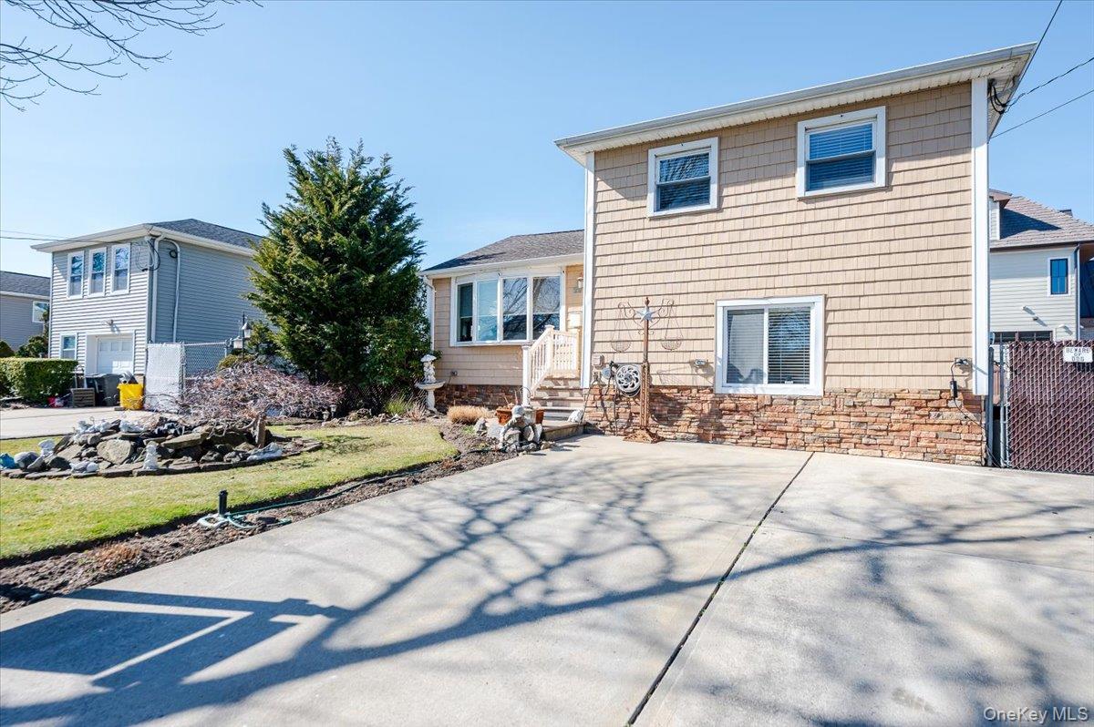 22 Cheshire Road Inwood, NY 11096 - Photo 24 of 25 a view of house with yard and sitting area