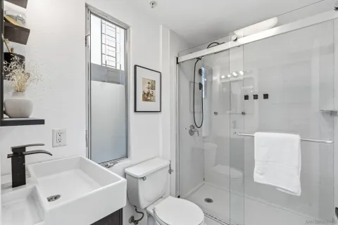 a bathroom with a sink toilet and shower