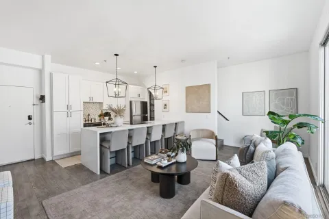 a living room with furniture and view of kitchen