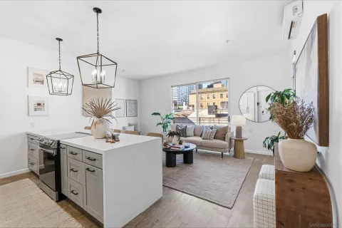 a living room with furniture a chandelier and a dining table