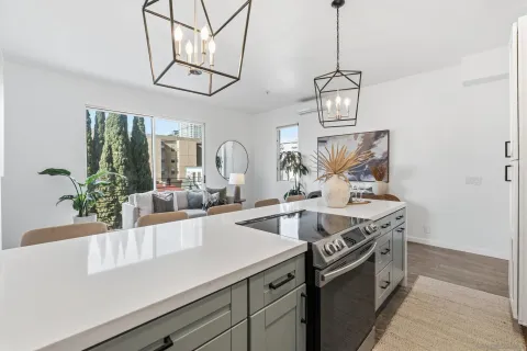 a kitchen with stainless steel appliances granite countertop a sink and a stove