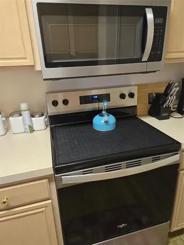 a stove top oven sitting inside of a kitchen