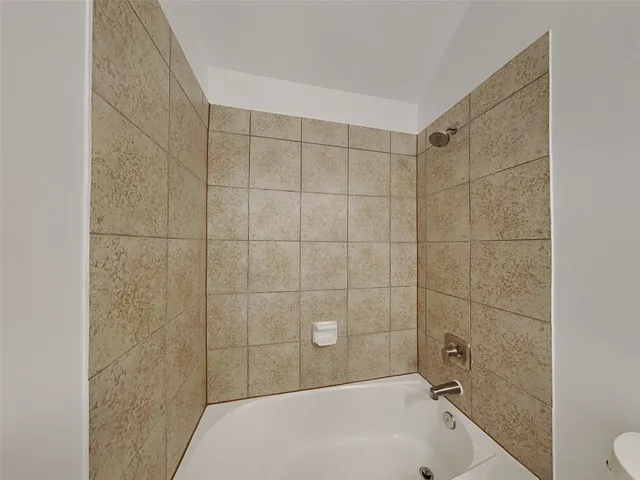 a bathroom with a bathtub and shower