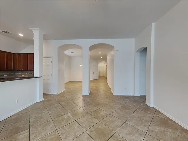 a view of a hallway with wooden shelves