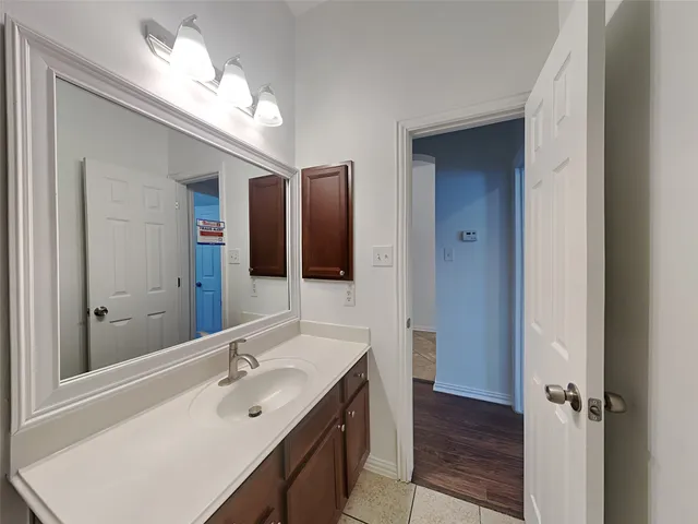 a bathroom with a double vanity sink and a mirror