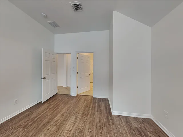 a view of room with wooden floor