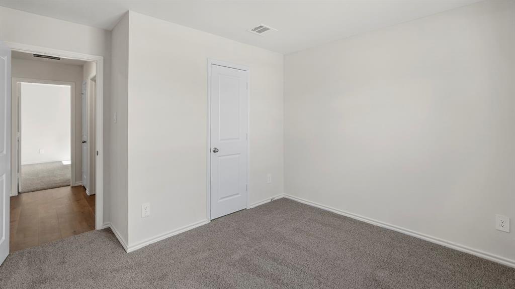 1969 Freeman Street Tyler, TX 75704 - Photo 18 of 30 Carpeted room with white walls, baseboards, and trim