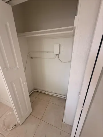 a kitchen with a refrigerator a stove top oven and cabinets