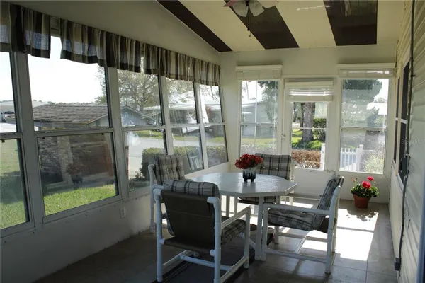 a view of a dining room with furniture and window