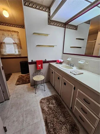 a bedroom with a bed mirror and window