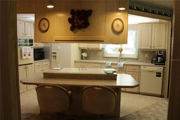 a kitchen with a stove and a refrigerator