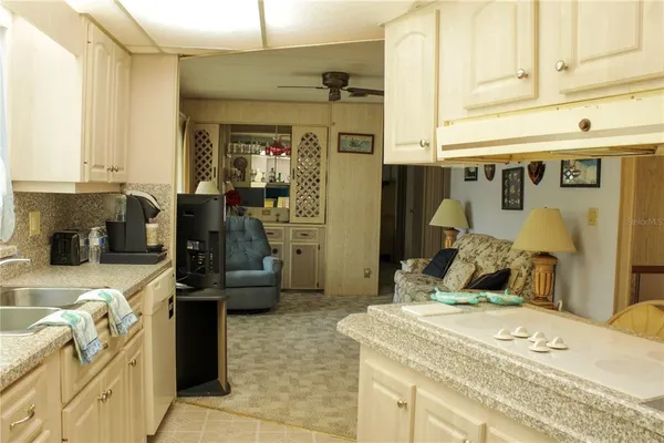 a kitchen with stainless steel appliances granite countertop a stove refrigerator and a microwave with wooden floor