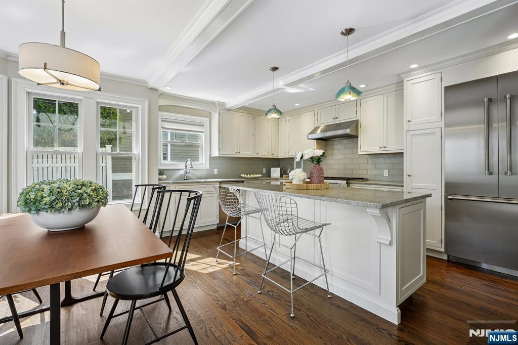 11 Mt Vernon Road Montclair, NJ 07043 - Photo 9 of 49 a kitchen with granite countertop a table chairs a sink dishwasher window and cabinets