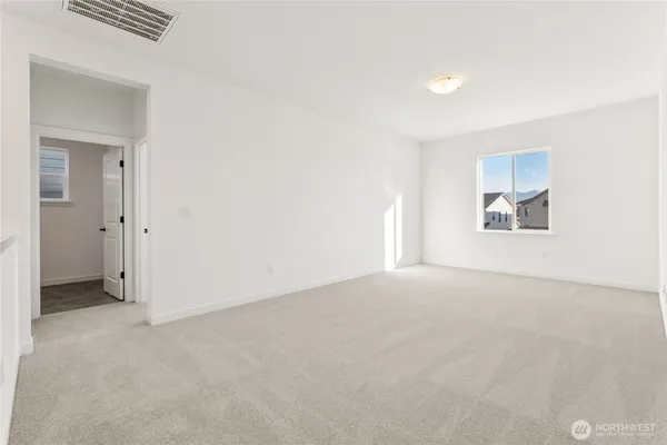 an empty room with windows and closet