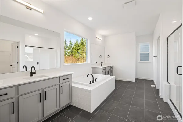a bathroom with a sink a tub and a mirror