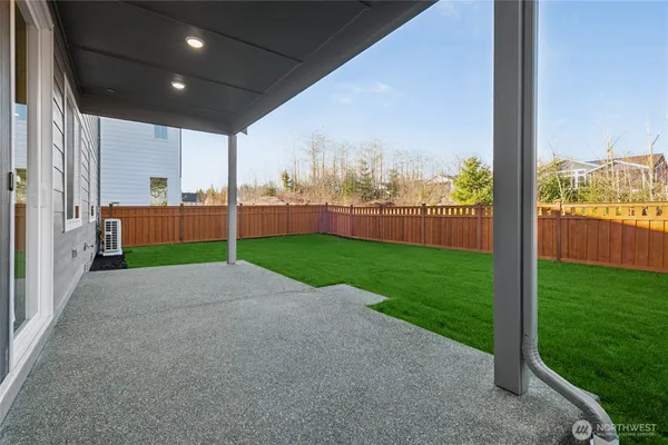 a house with green field in front of it