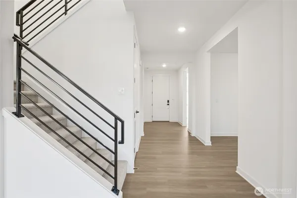a view of a hallway with wooden floor