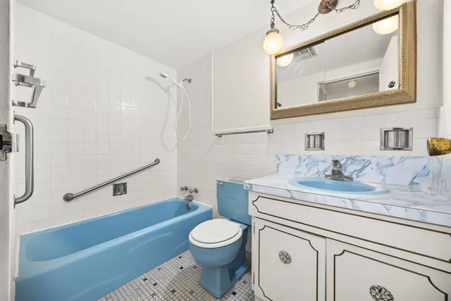 a bathroom with a sink a toilet and a mirror