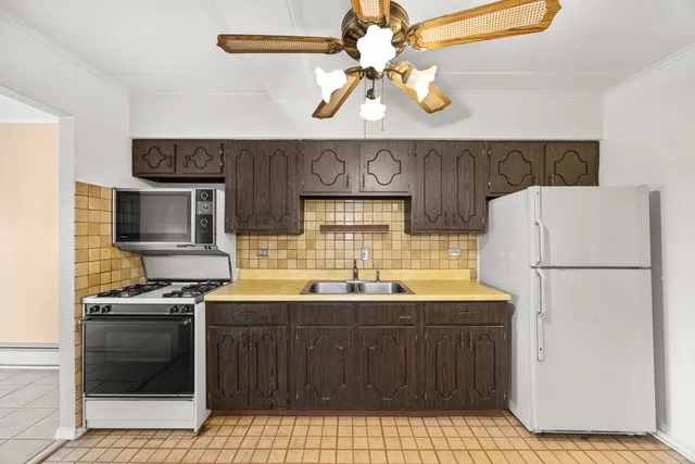 a kitchen with a sink a stove and a refrigerator