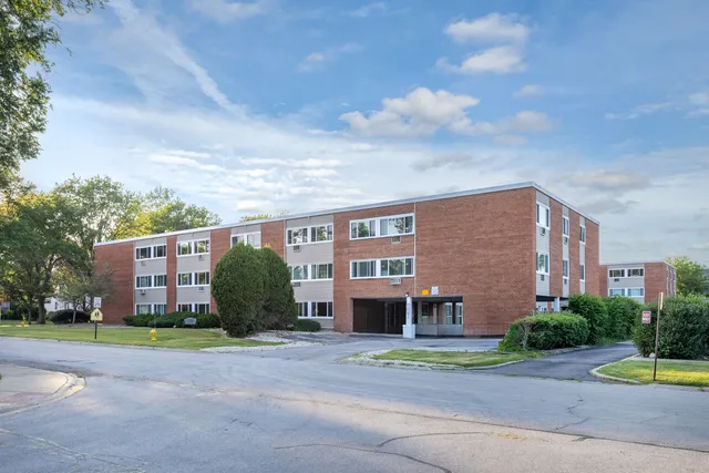 a view of a brick building next to a yard